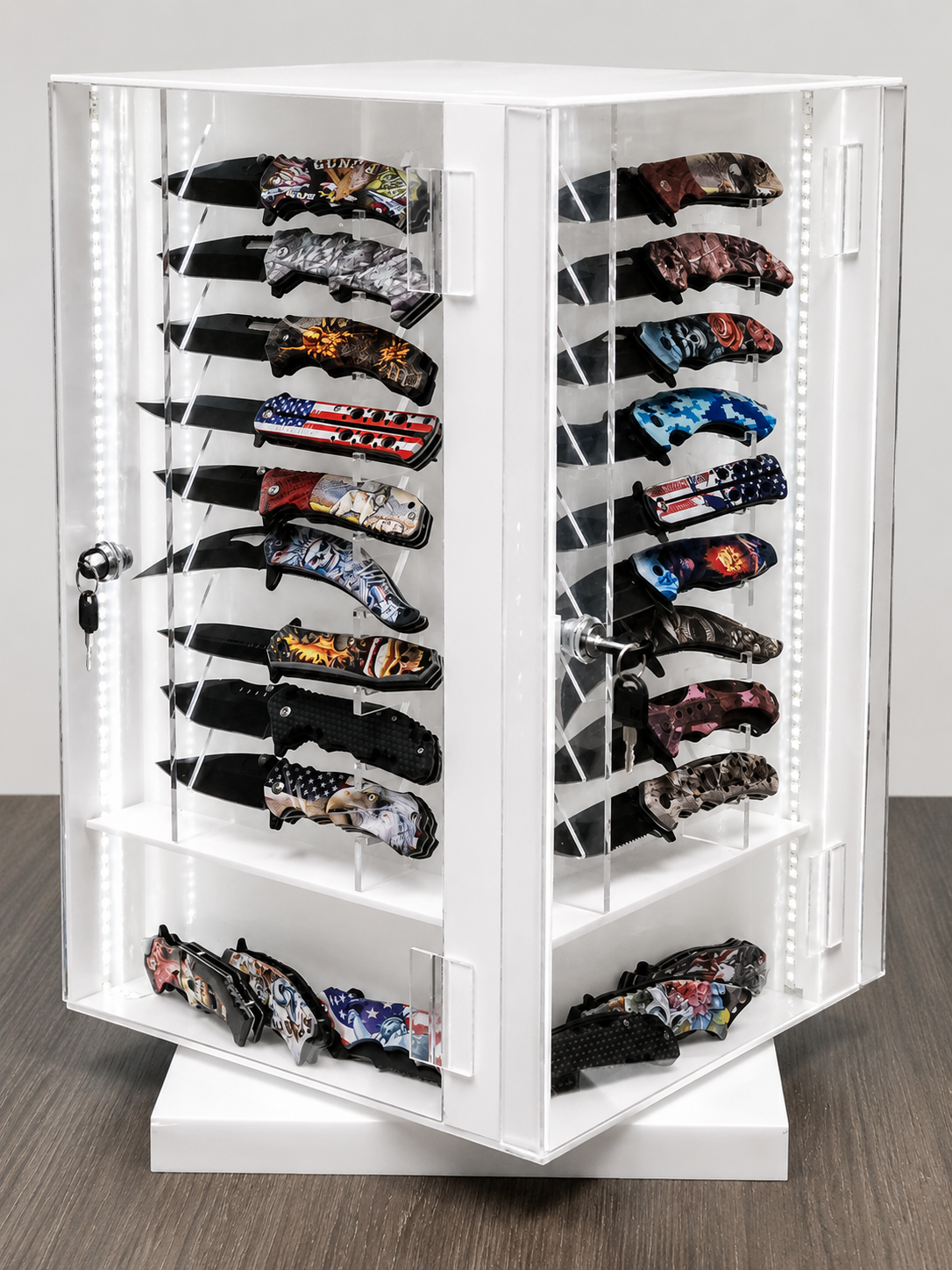 White acrylic LED knife display case with locking doors and multiple knives mounted inside